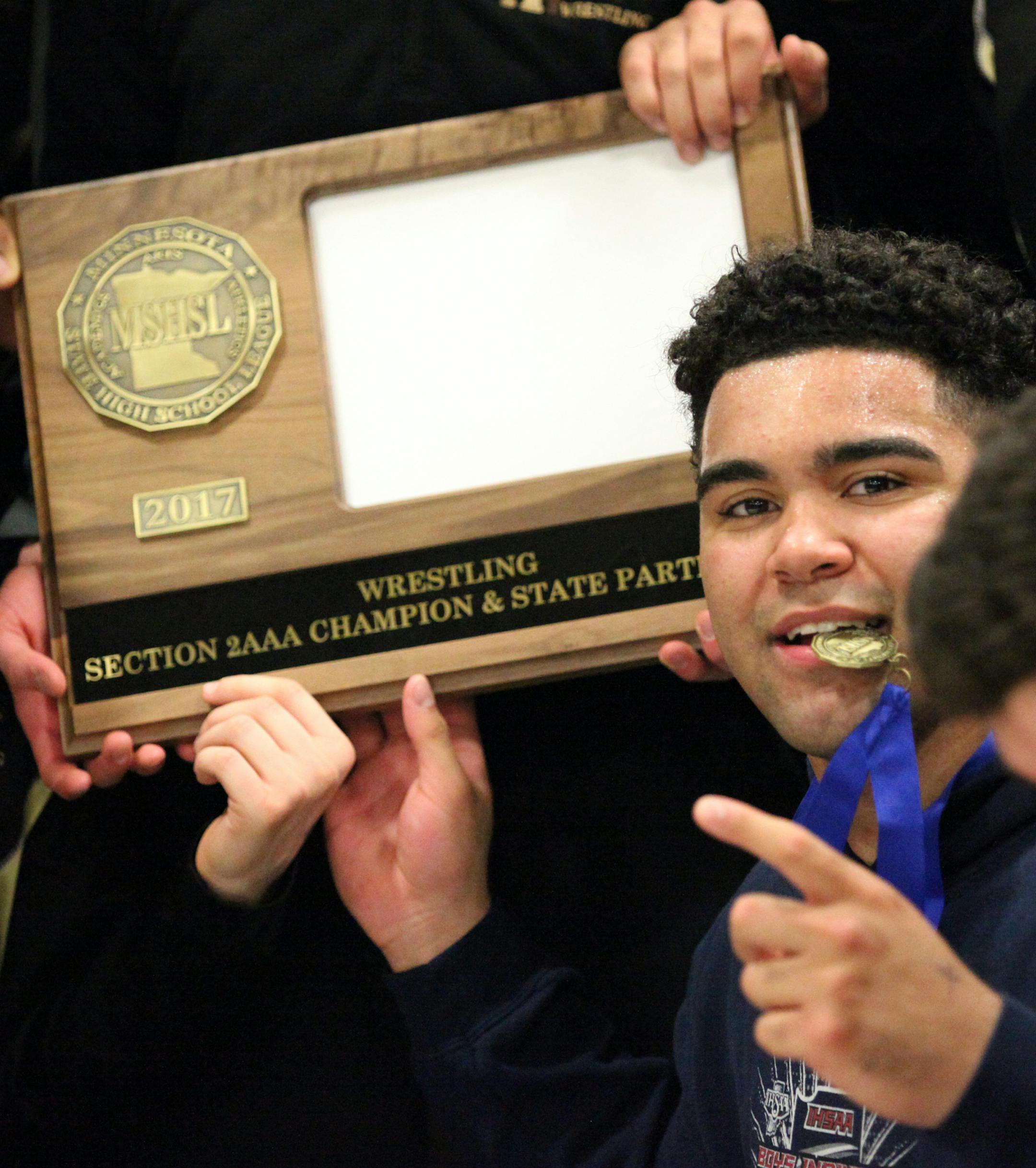 Apple Valley Eagles Gable Steveson and team members bite the gold medal. ] XAVIER WANG &#x2022; xavier.wang@startribune.com Game actions from 2017 Section 2AAA Team Wrestling Tournament final section between the Shakopee Sabers and Apple Valley Eagles Friday. Feb, 17. 2017 at Rosemount High School in Rosemount, Minnesota.