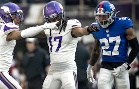 Minnesota Vikings wide receiver Justin Jefferson (18) celebrates a first down catch with K.J. Osborn (17) in the third quarter in Minneapolis, Minn., 