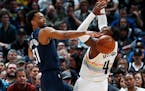 Timberwolves forward Keita Bates-Diop, left, stole the ball from Nuggets forward Paul Millsap during the first half Wednesday.