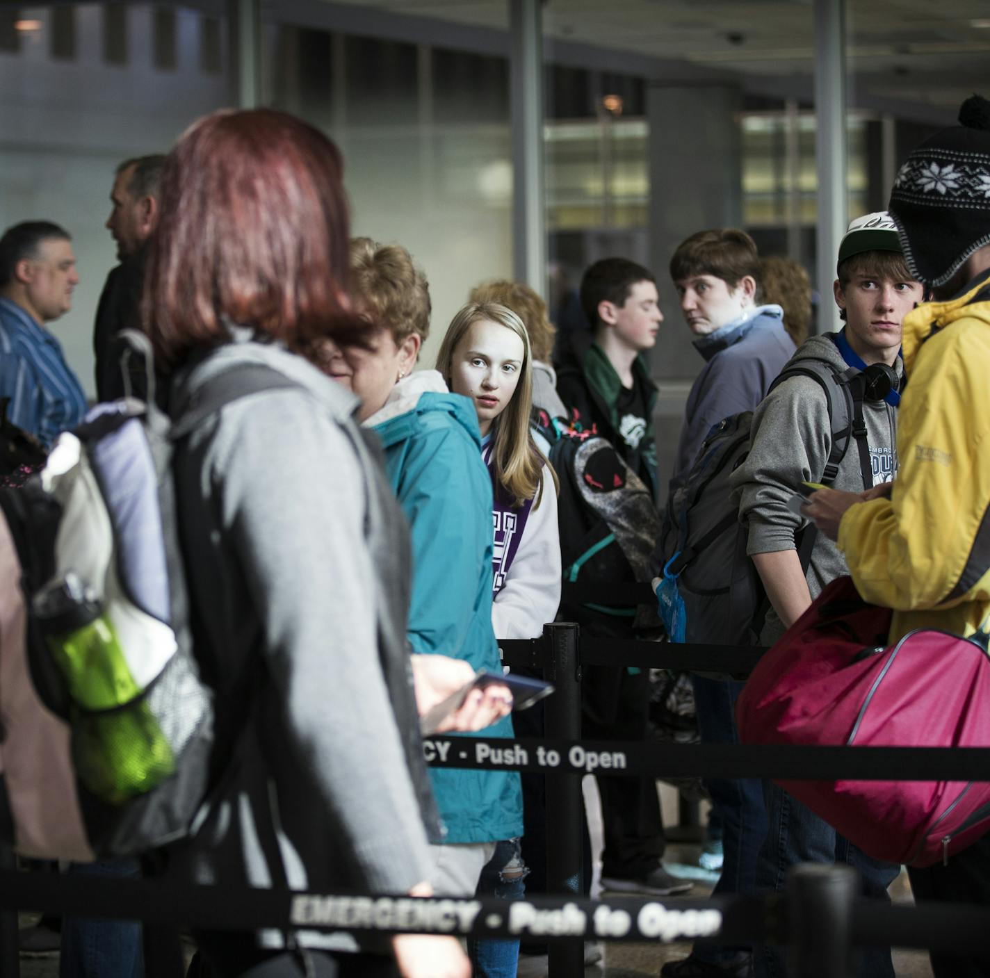 Passengers wait in line at a checkpoint at Terminal 1.