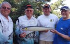 The Stony Point Fish Camp traveling trophy of a Rapala lure replica was reluctantly conceded this year to fishing contest winners Dick Stoltman, far l