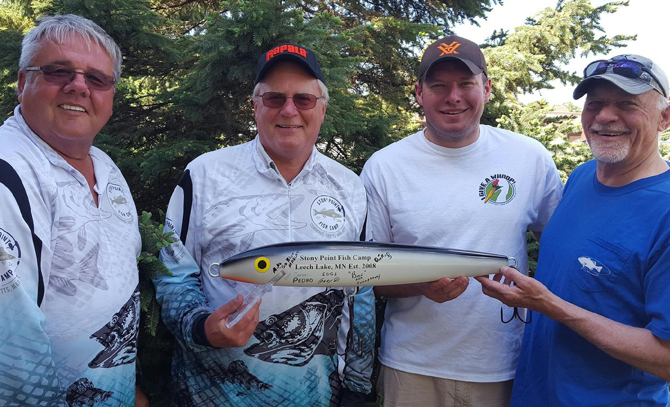 The Stony Point Fish Camp traveling trophy of a Rapala lure replica was reluctantly conceded this year to fishing contest winners Dick Stoltman, far left, and Gary Drotts, second from left, by Pete and Greg Kvale. The anglers are from the Brainerd area.