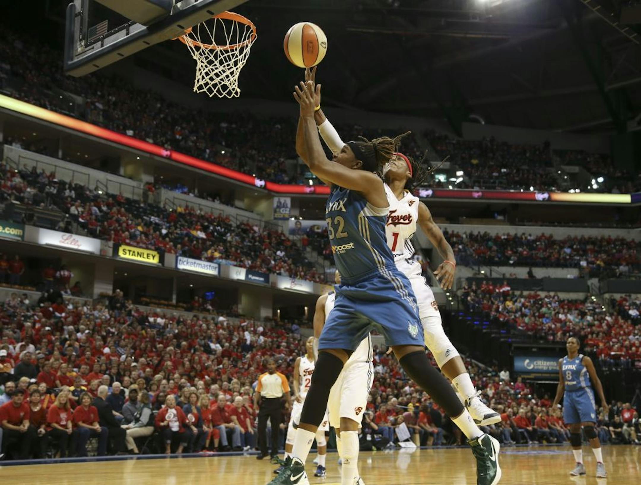 Indiana Fever�s Shavonte Zellous, #1, gets her hand on the ball as Minnesota Lynx�s Rebekkah Brunson, #32, goes for the point in the first quarter of game 3 of the WNBA Finals at Bankers Life Fieldhouse in Indianapolis Ind., Friday October 19, 2012.