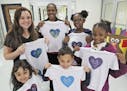 From left, back, Nikki Rajahn, North Fayette Elementary School Principal Lisa Moore, Madison and Morghan Reckley, Brooklyn and Blake Rajahn show off s