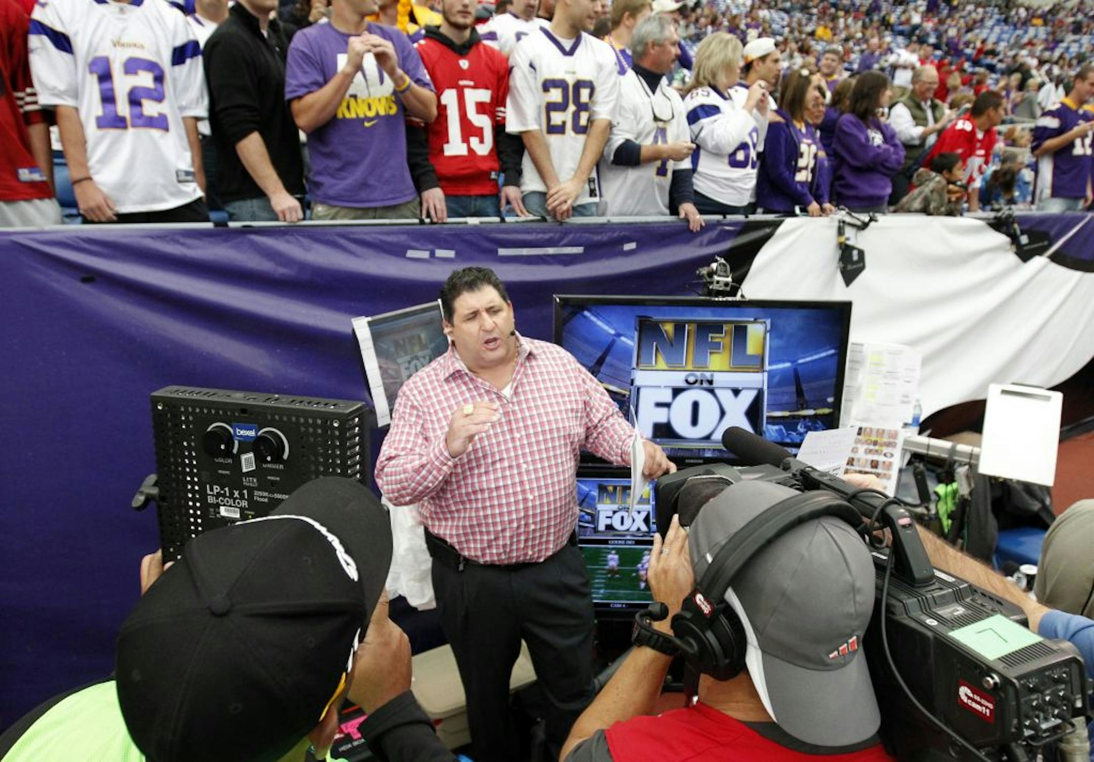 Fox broadcaster Tony Siragusa stays close to the action, as seen while he did a segment before the start of the game between the Vikings and 49ers.