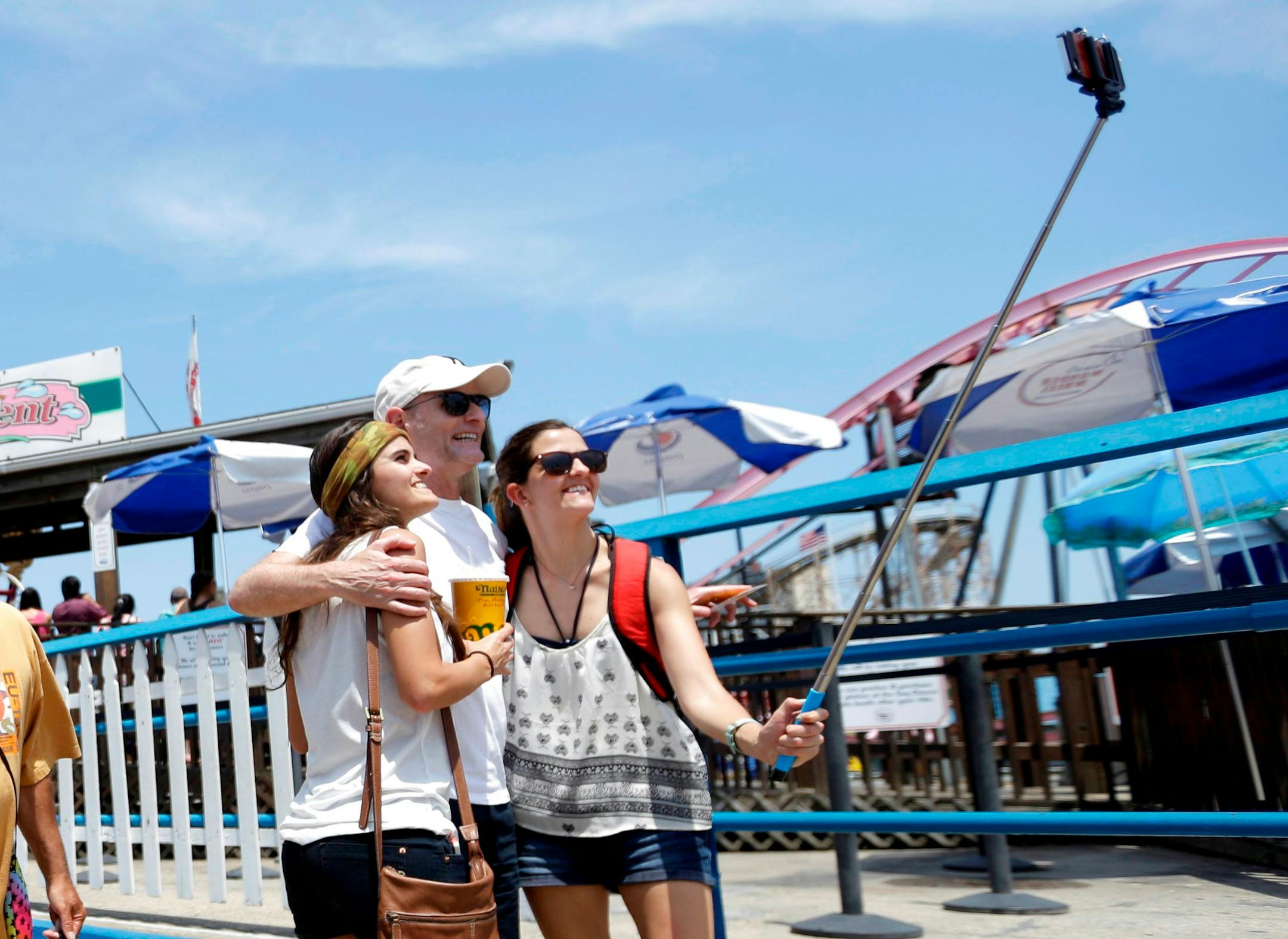 Visitors to Coney Island in Brooklyn, N.Y., used a selfie stick to take a photo.