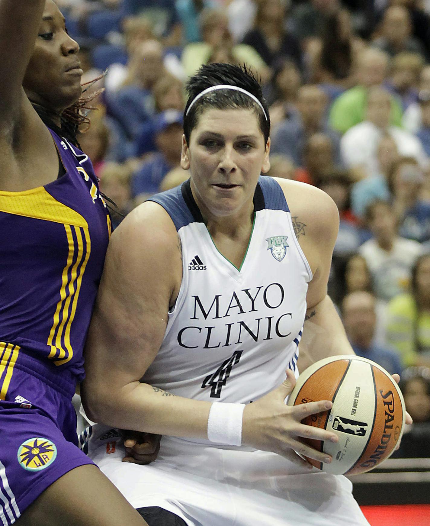 Minnesota Lynx center Janel McCarville (4) protects the ball against Los Angeles Sparks center Jantel Lavender (42) in the second half of a WNBA basketball game, Tuesday, July 8, 2014, in Minneapolis. The Lynx won 83-72. (AP Photo/Stacy Bengs) ORG XMIT: MIN2014080818501167