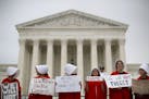 Activists protest in front of the Supreme Court in Washington, Tuesday, Oct. 9, 2018. A Supreme Court with a new conservative majority takes the bench