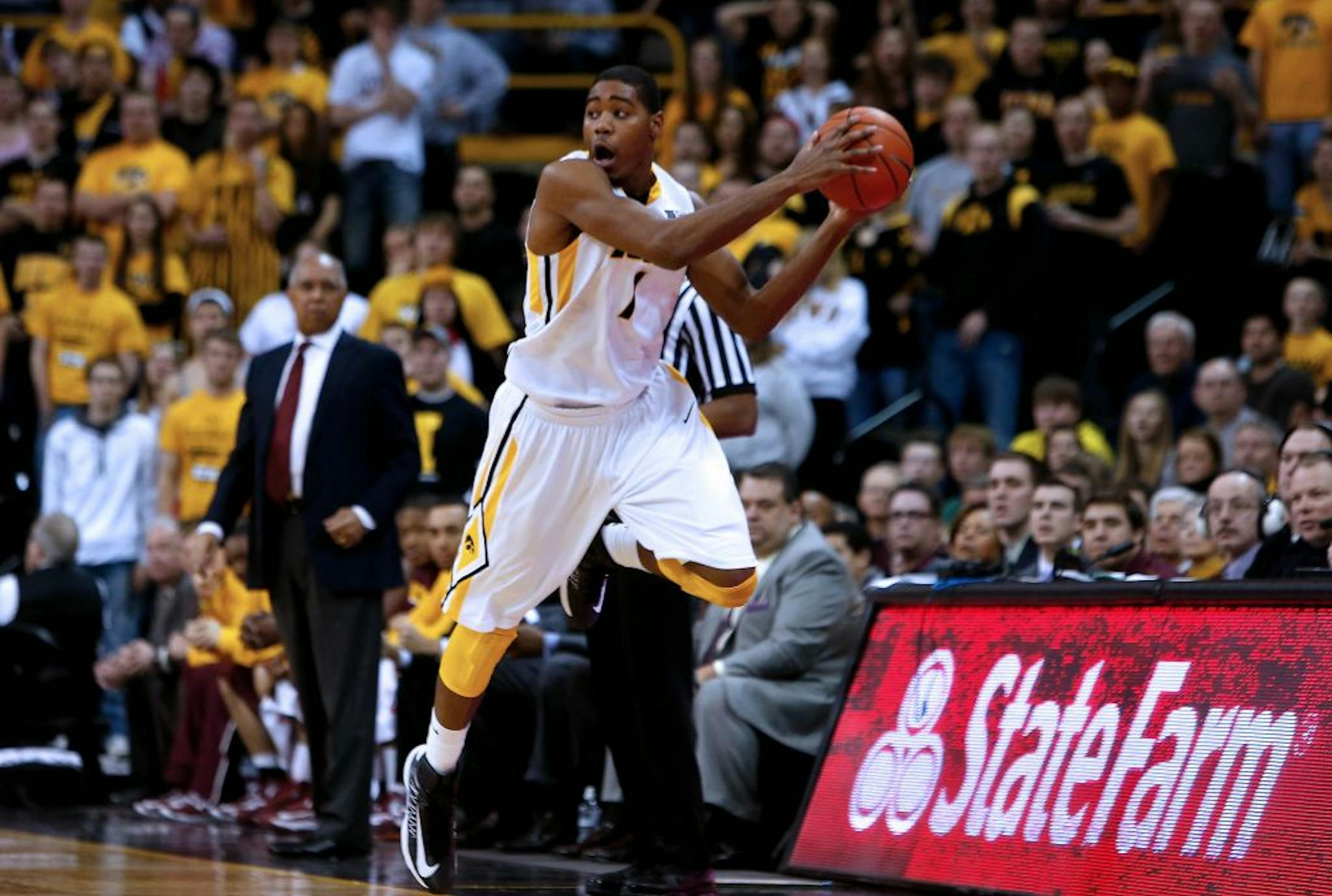 Iowa forward Melsahn Basabe (1) saves the ball from going out of bounds after a steal during the second half of an NCAA college basketball game against Minnesota, Sunday, Feb. 17, 2013, in Iowa City, Iowa.