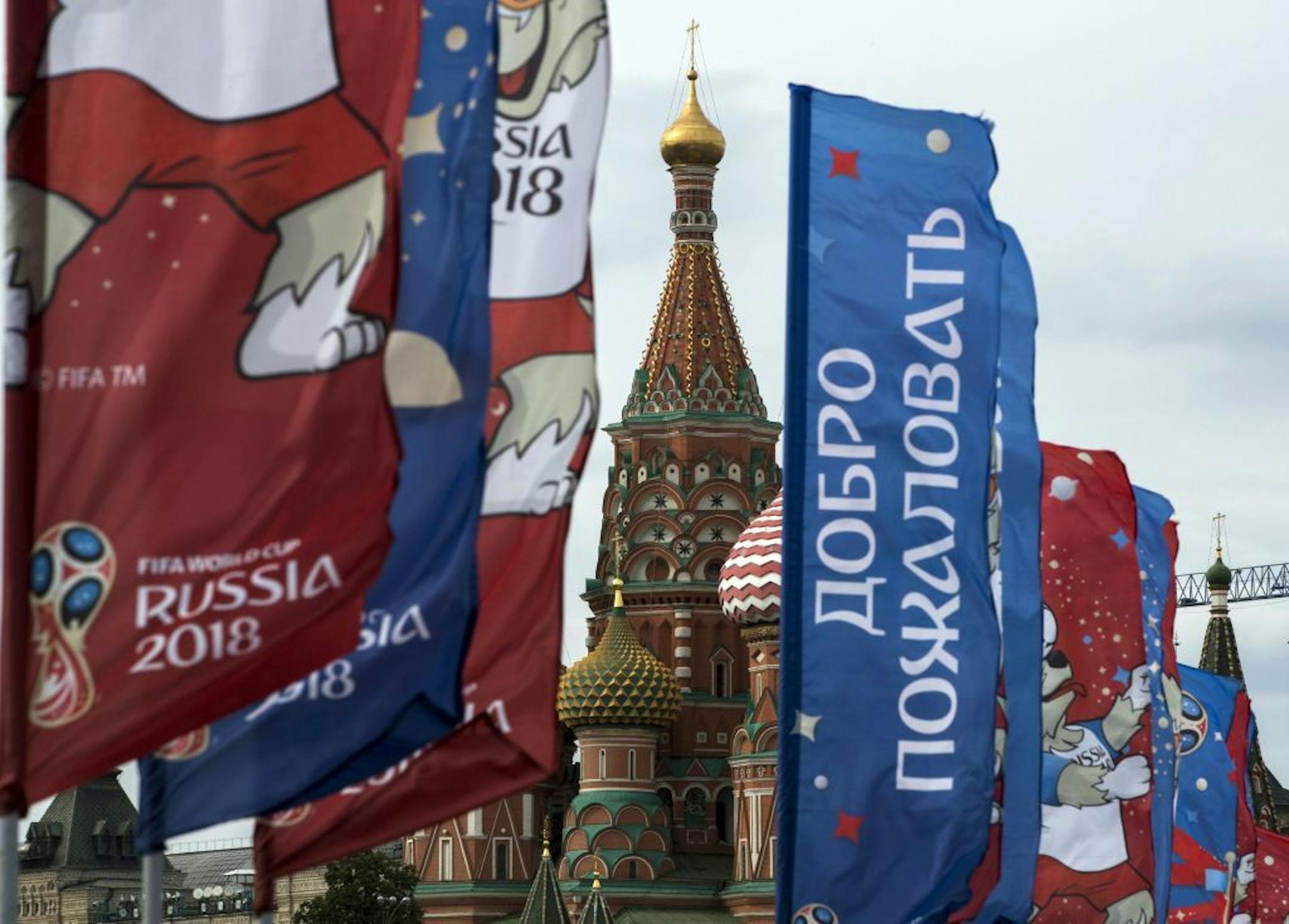 Flags with the logo of the World Cup 2018 are displayed with the St. Basil's Cathedral in the background, in Moscow, Russia, Monday, June 4, 2018. The sign on central flag reads: "Welcome".