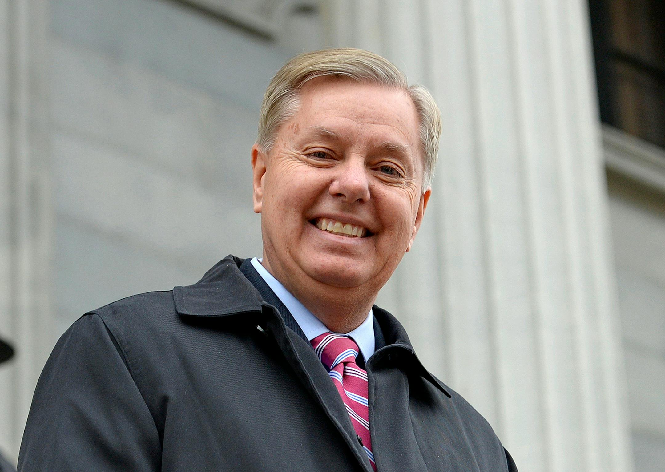 In this Jan. 14, 2015 file photo, Sen. Lindsay Graham, R- S.C., walks down the steps of the State Capitol building in Columbia, S.C. Republican presidential candidate Graham announced last week that he is ending his bid for the GOP nomination.