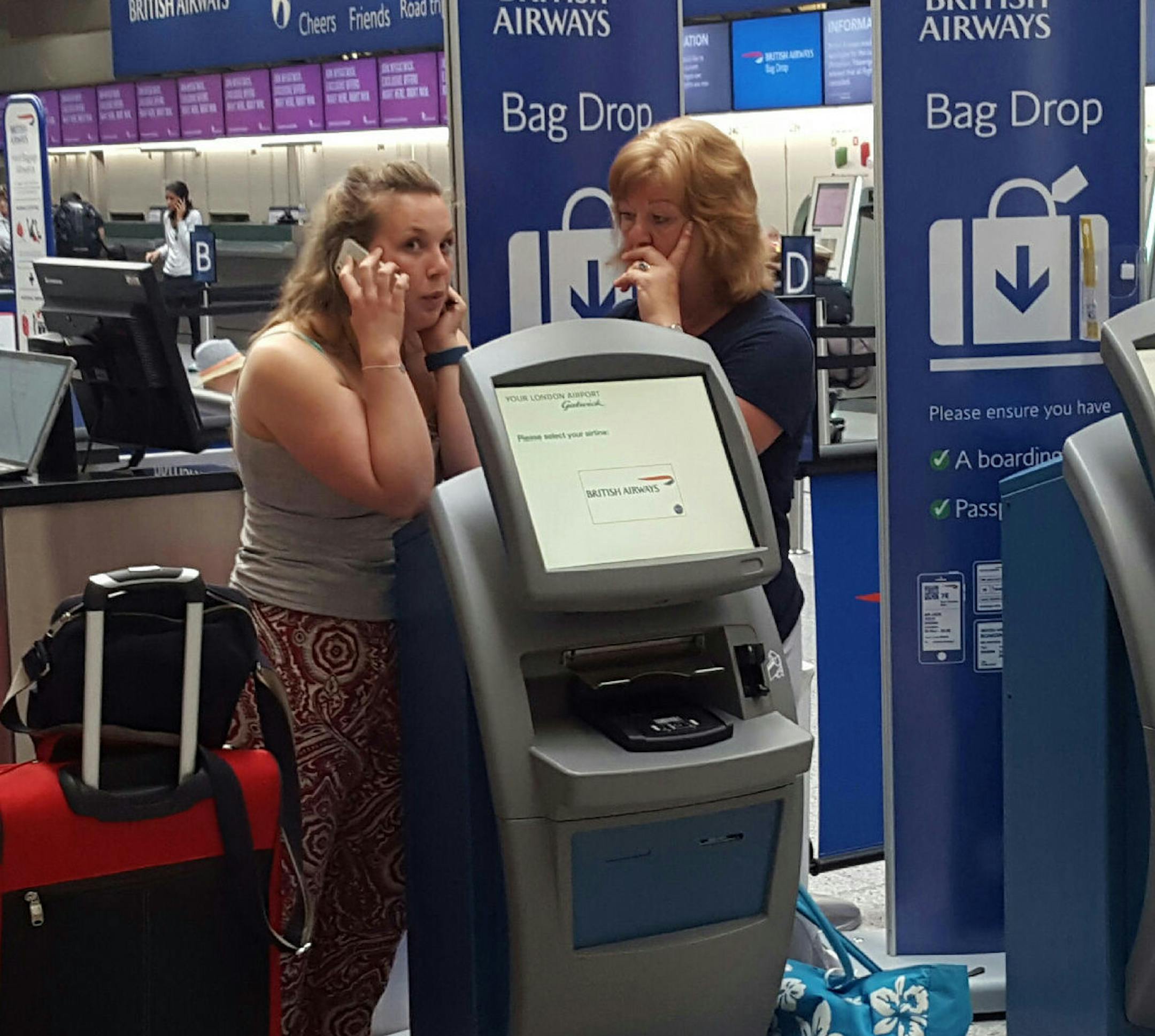 Passengers stand at a British Airways check-in desk after the airport suffered an IT systems failure, at London''s Gatwick Airport, Saturday, May 27, 2017. British Airways canceled all flights from London's Heathrow and Gatwick airports Saturday as a global IT failure caused severe disruption for travelers on a busy holiday weekend. (Gareth Fuller/PA via AP)