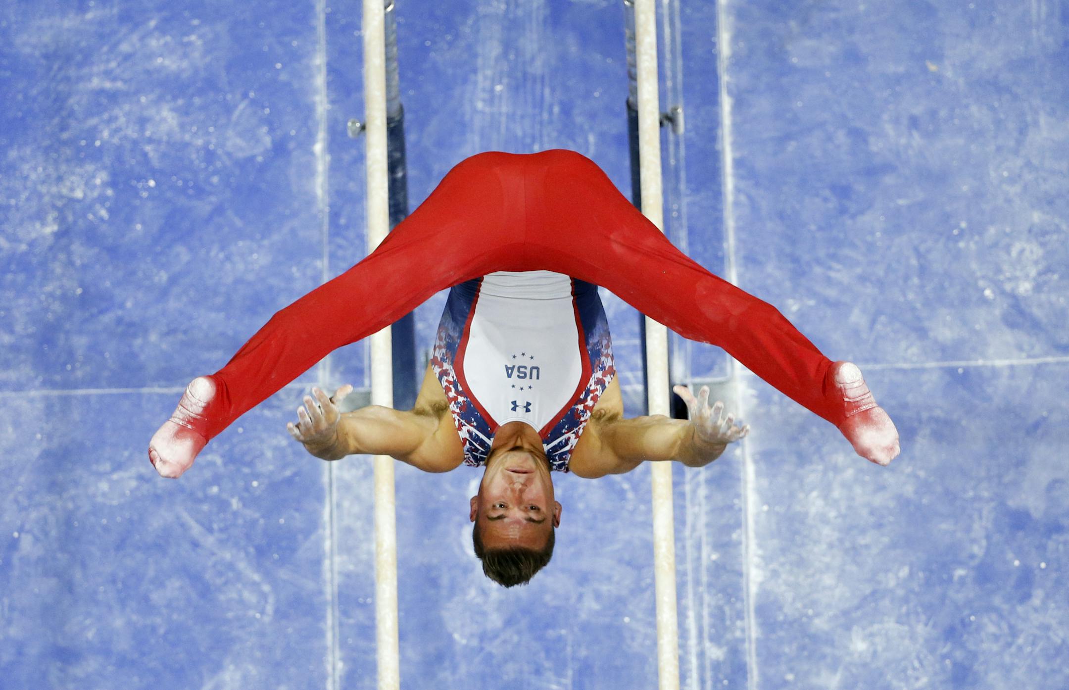 Sam Mikulak competes on the parallel bars during the U.S men's Olympic gymnastics trials, Saturday, June 25, 2016, in St. Louis. (AP Photo/Tony Gutierrez)
