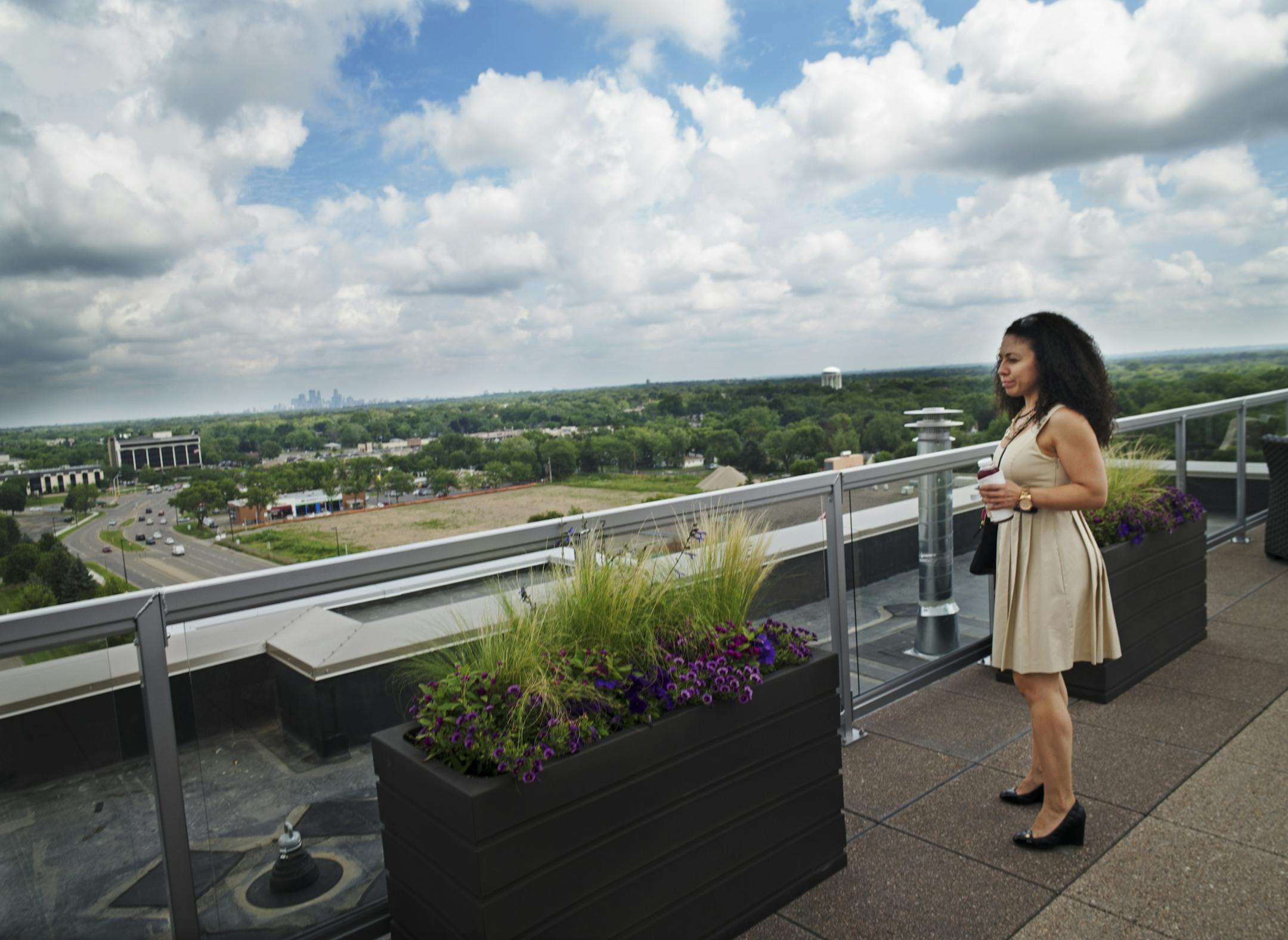 At One Southdale Apartments in Edina, leasing consultant Irma Reyes who just moved here from Chicago checks out the rooftop deck as well as a two-bedroom apartment for her and her son.