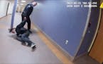This screengrab from a Duluth police officer’s body camera shows officer Adam Huot dragging a handcuffed man through the city’s skywalk moments be