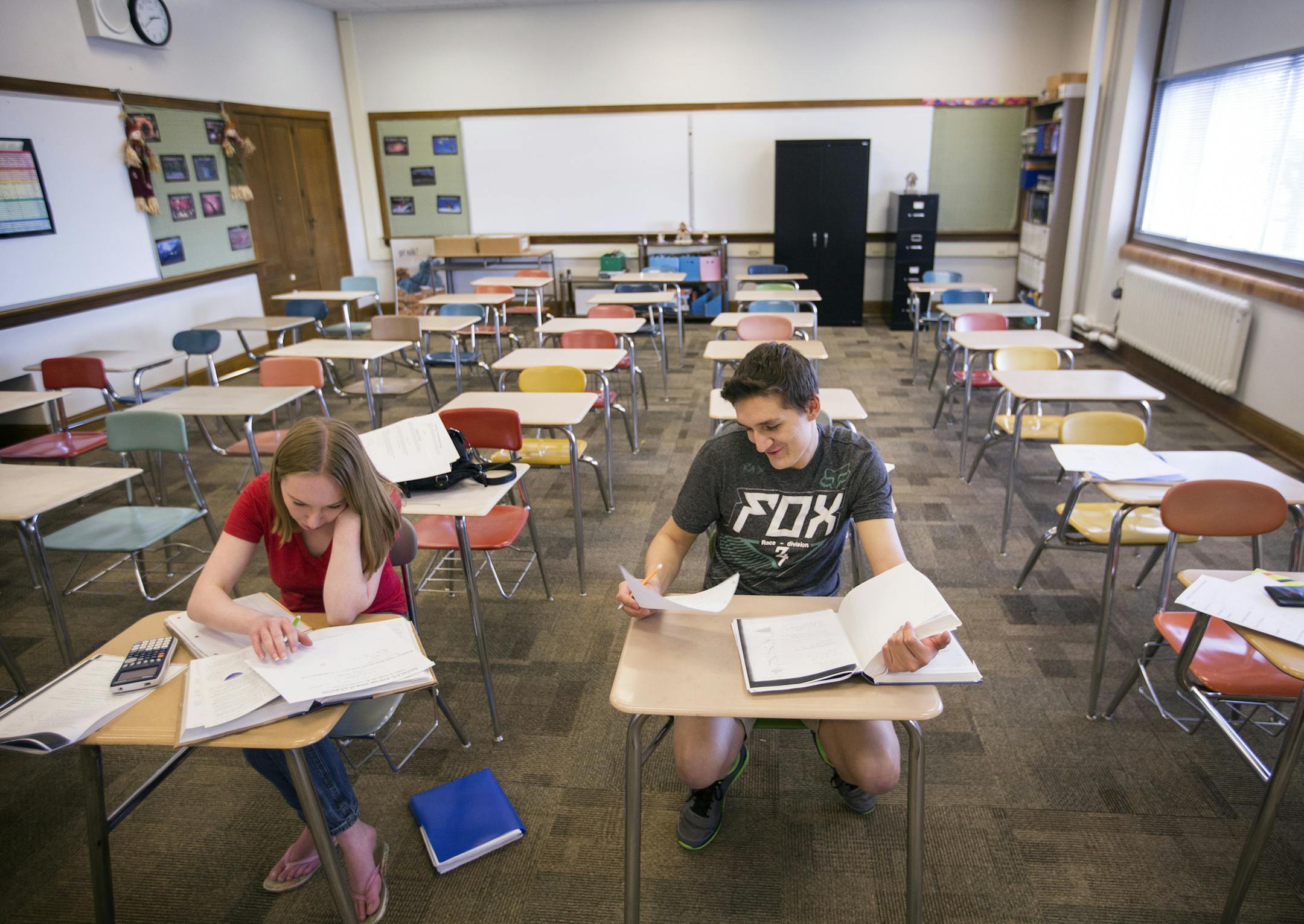 Mitchell Masters, center, does work in his AP Calculus class, which has only three students. ] (Leila Navidi/Star Tribune) leila.navidi@startribune.com BACKGROUND INFORMATION: Mitchell Masters, a senior at Eveleth-Gilbert HIgh School, comes from a family of miners, his cousin and uncle are currently laid off from their mining jobs and his dad was temporarily laid off last year. Masters is currently working two jobs to help pay for the Iron Range Engineering program at Mesabi Range College, which