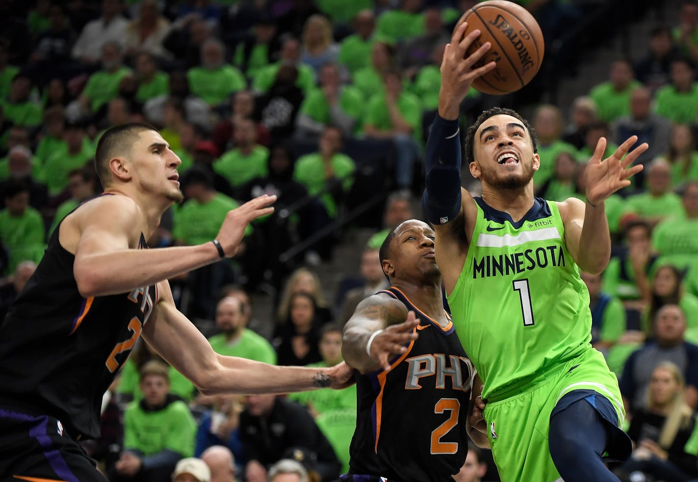 Tyus Jones (1) attempts a layup, drawing a foul on the Phoenix Suns' Isaiah Canaan, in the third quarter on Saturday, Dec. 16, 2017, at Target Center in Minneapolis.