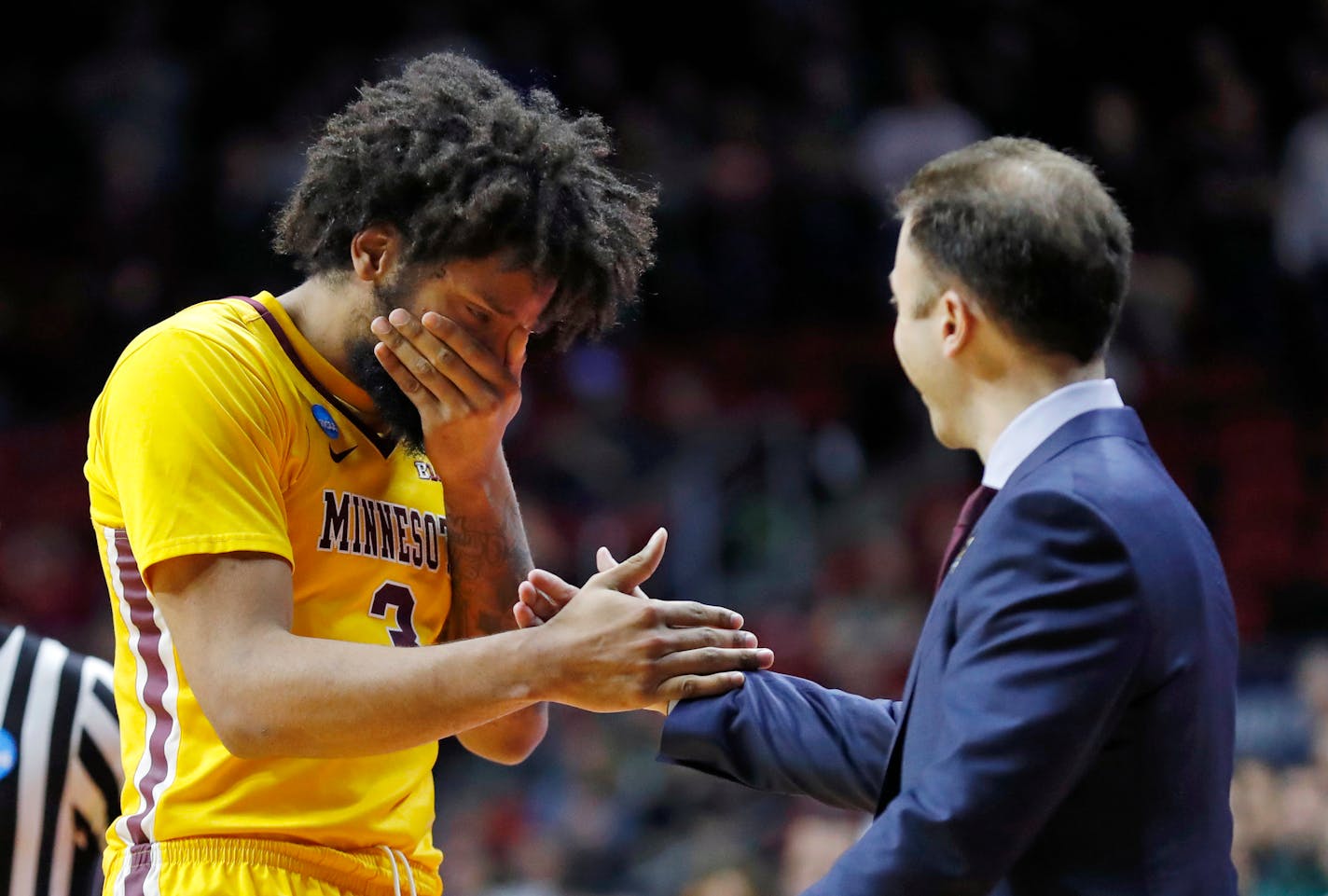 Gophers forward Jordan Murphy reacts with coach Richard Pitino at the end of the game.