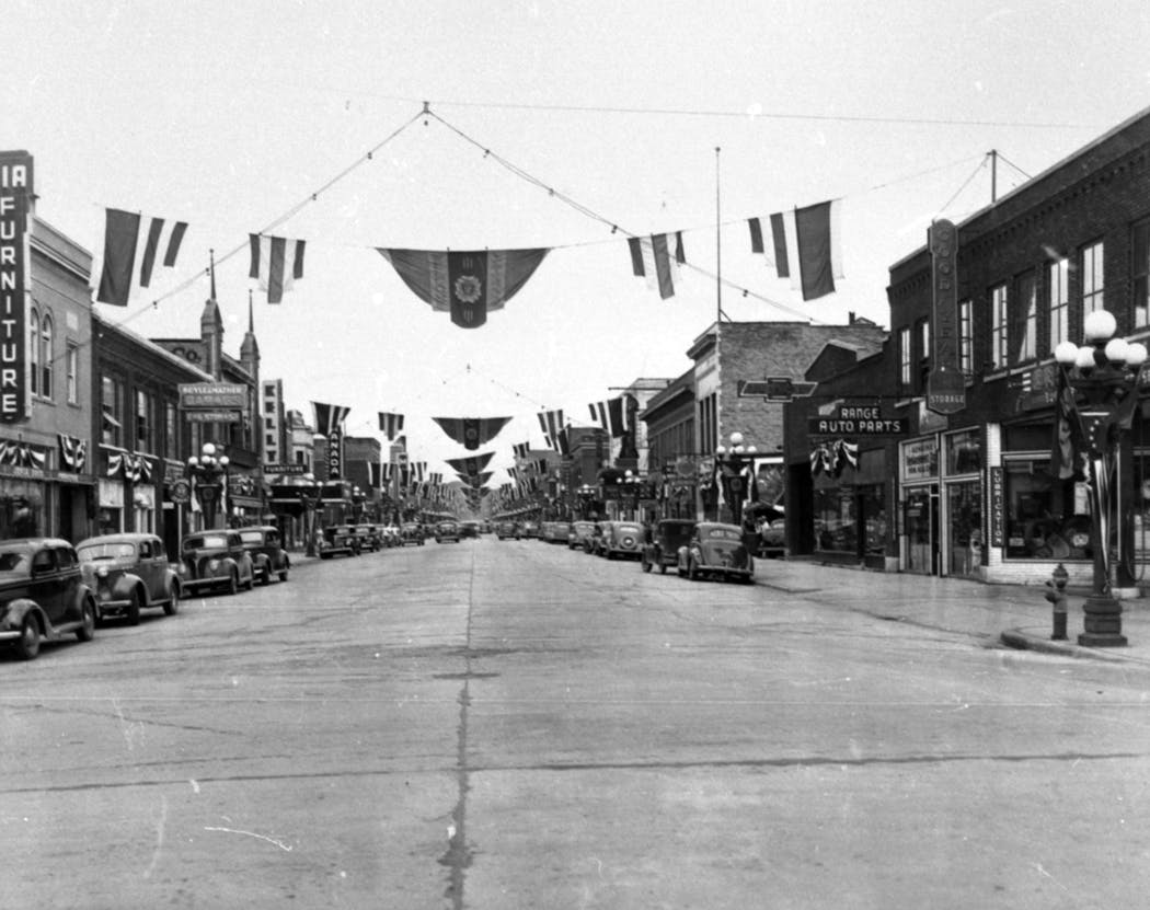 Banners welcoming veterans of foreign wars hung over Chestnut Street in Virginia, Minnesota in this 1940s photograph.