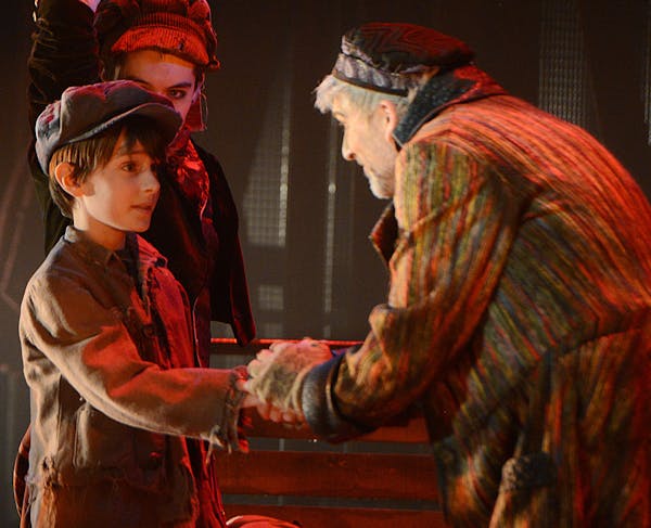 Fagin, played by Bradley Greenwald, speaks to Oliver, played by Nate Turcotte, during a rehearsal of "Oliver!". ] PHOTO SPECIAL TO THE STAR TRIBUNE BR