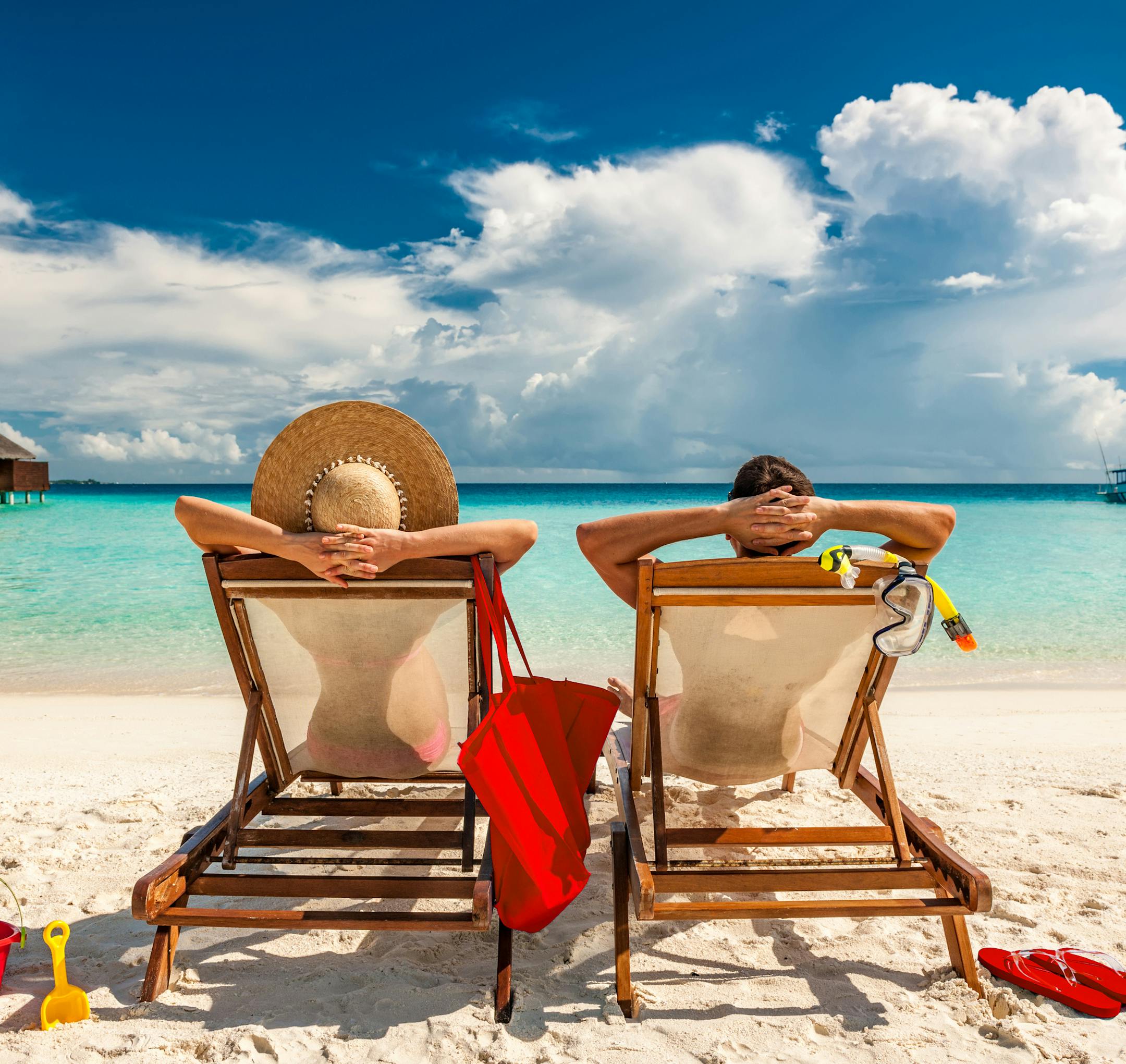 Couple in loungers on a tropical beach at Maldives. istock
