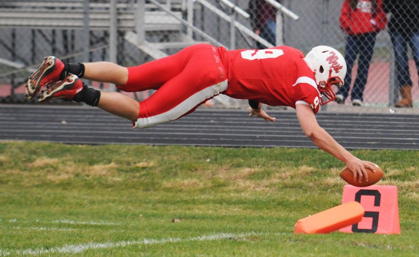 Mankato West's Philip Nelson dives into the endzone for a touchdown during his senior year in 2011. He's facing assault charges and an uncertain fate stemming form an incident in Mankato on Saturday night.