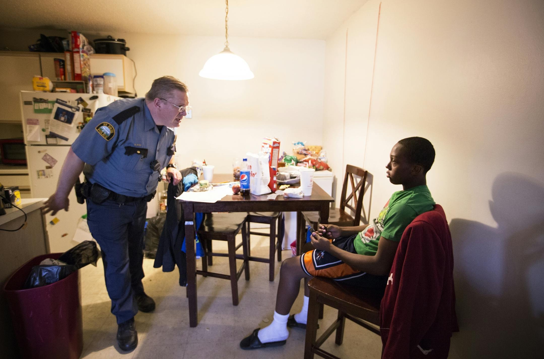St. Paul Police officer Rob Zink visits with Devont'e Ray-Burns, 12, who has autism and other disabilities, at Ray-Burns' home in St. Paul on Thursday, July 9, 2015.
