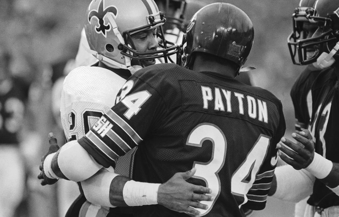 New Orleans Saints? Russell Gary, left, is among the first to congratulate Chicago Bears? Walter Payton after Payton overtook Jim Brown's NFL rushing recoed during third quarter action on Sunday, Oct. 8, 1984 in Chicago. Payton finished the game with 154 yards on 32 carries, giving him 12,400 yards for his career, 88 more than Brown. The Bears won, 20-7. (AP Photo/Marcia Rules) ORG XMIT: APHS278907