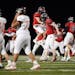 Shakopee running back Seth Bakken (20) and linebacker Sam Treml (40) celebrated the win as the Farmington players walked off the field at the end of t
