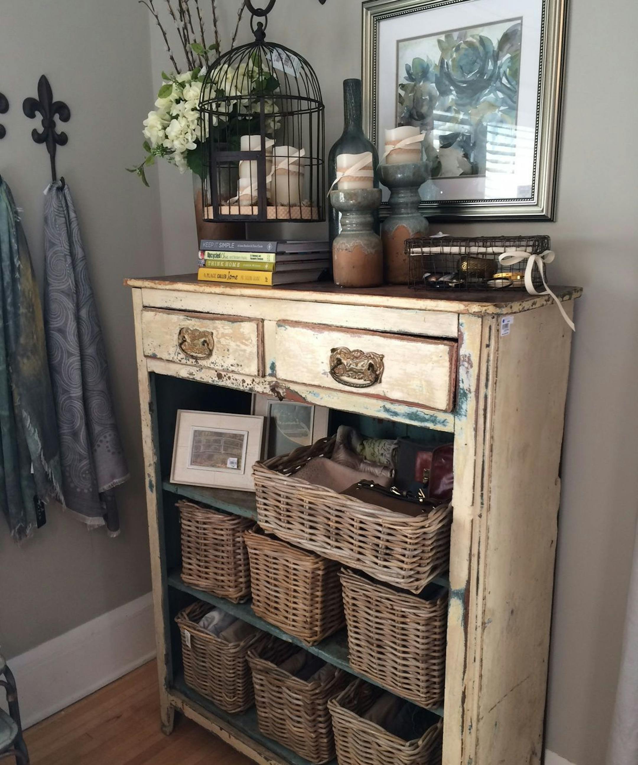 Vintage dresser with basket storage in a bedroom.