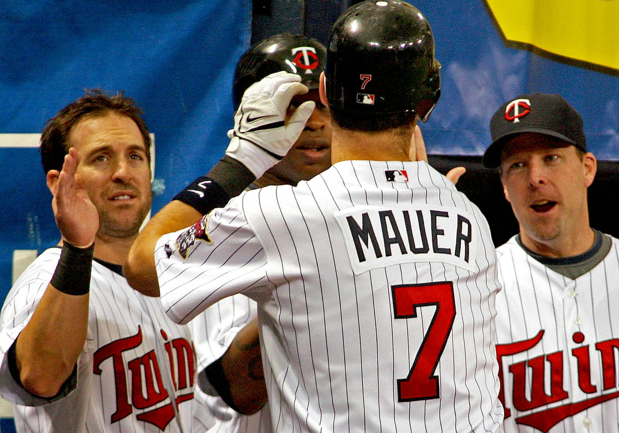 Twins Joe Mauer was congratulated by teammates after he hit a home run in the 1st inning.