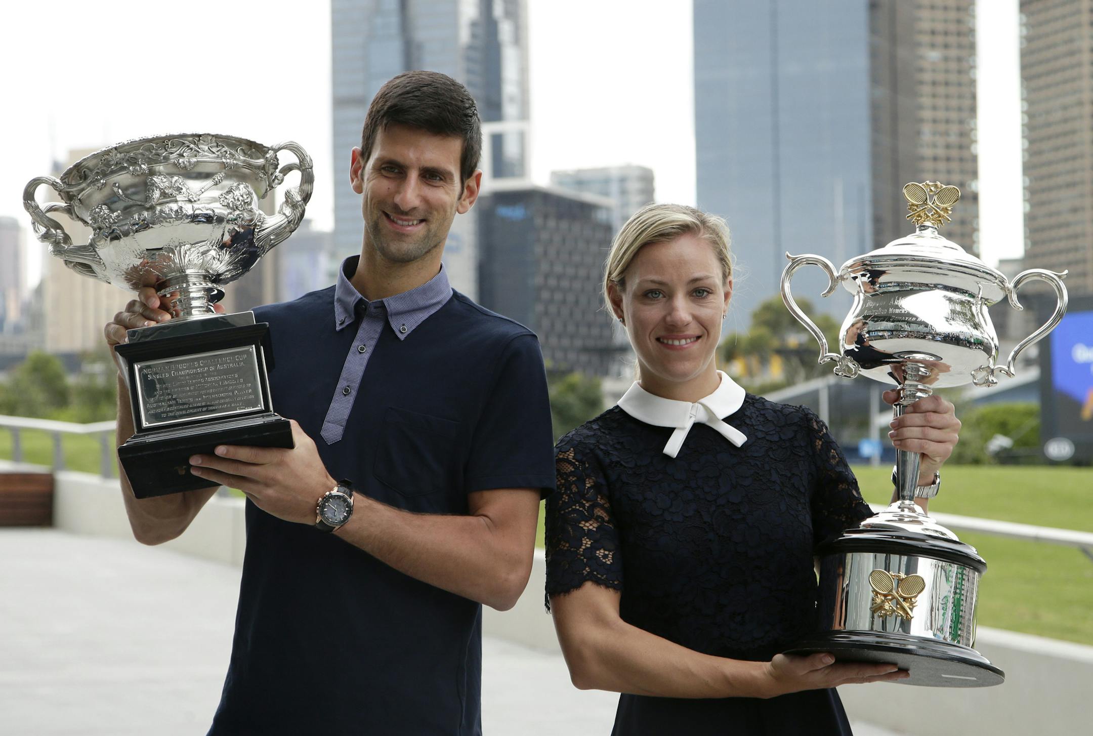 Defending men's and woman's champions Serbia's Novak Djokovic, left, and Germany's Angelique Kerber pose with their trophies prior to the official draw ceremony ahead of the Australian Open tennis championships in Melbourne, Australia, Friday, Jan. 13, 2017. (AP Photo/Mark Baker)