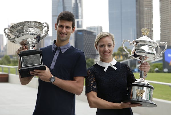Defending men's and woman's champions Serbia's Novak Djokovic, left, and Germany's Angelique Kerber pose with their trophies prior to the official dra