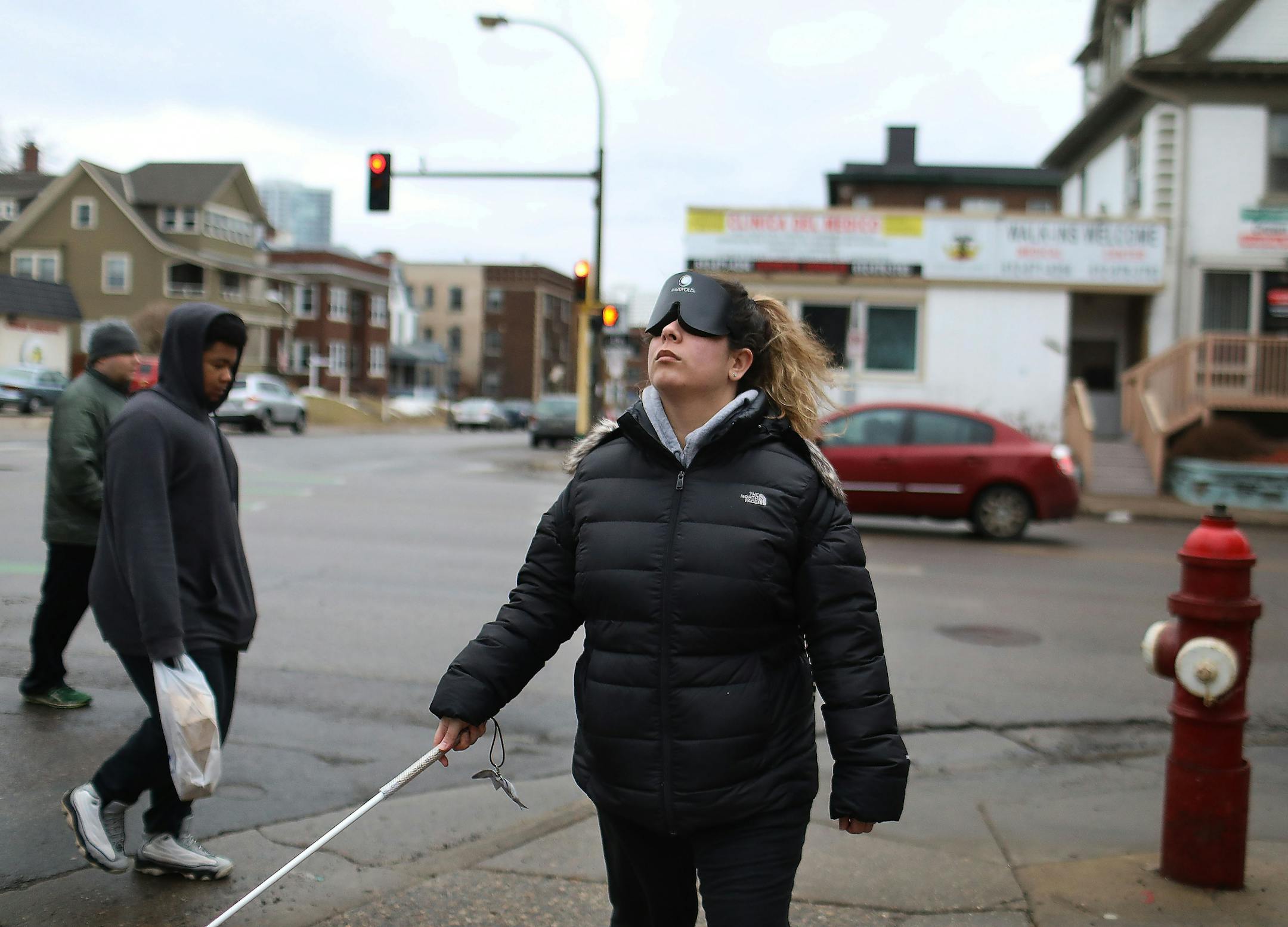 Through a class at Blind, Inc. Angie Castro, 30, is learning to navigate Minneapolis, including crossing busy streets around Blind, Inc. headquarters, near the Minneapolis Art Institute. Castro, wearing a sleep shade, was out with Mark Erickson, cane travel instructor, not, pictured, familiarizing herself with the city and bus routes Thursday, March 5, 2020, in Minneapolis, MN.