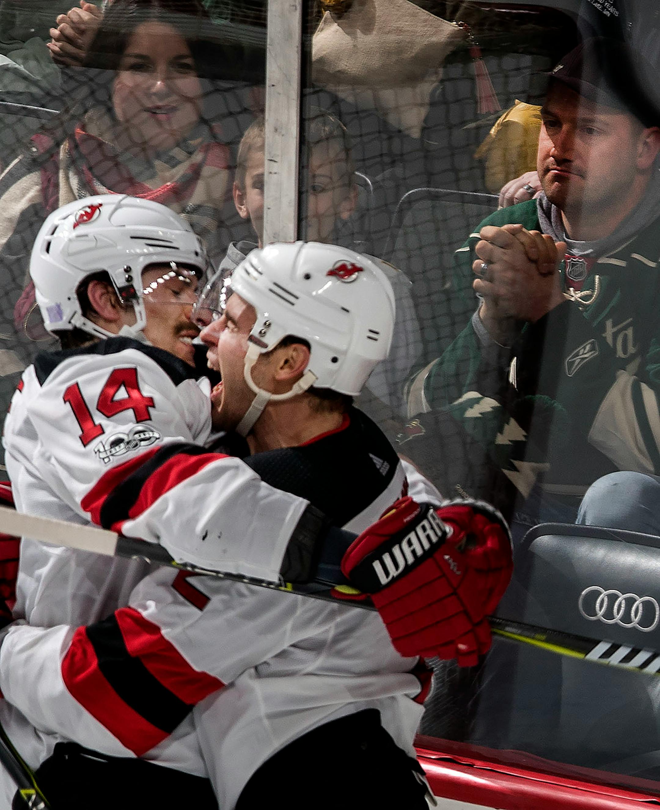 John Moore (2) and Adam Henrique (14) celebrated the game winning overtime goal by Moore. New Jersey beat Minnesota by a final score of 4-3.