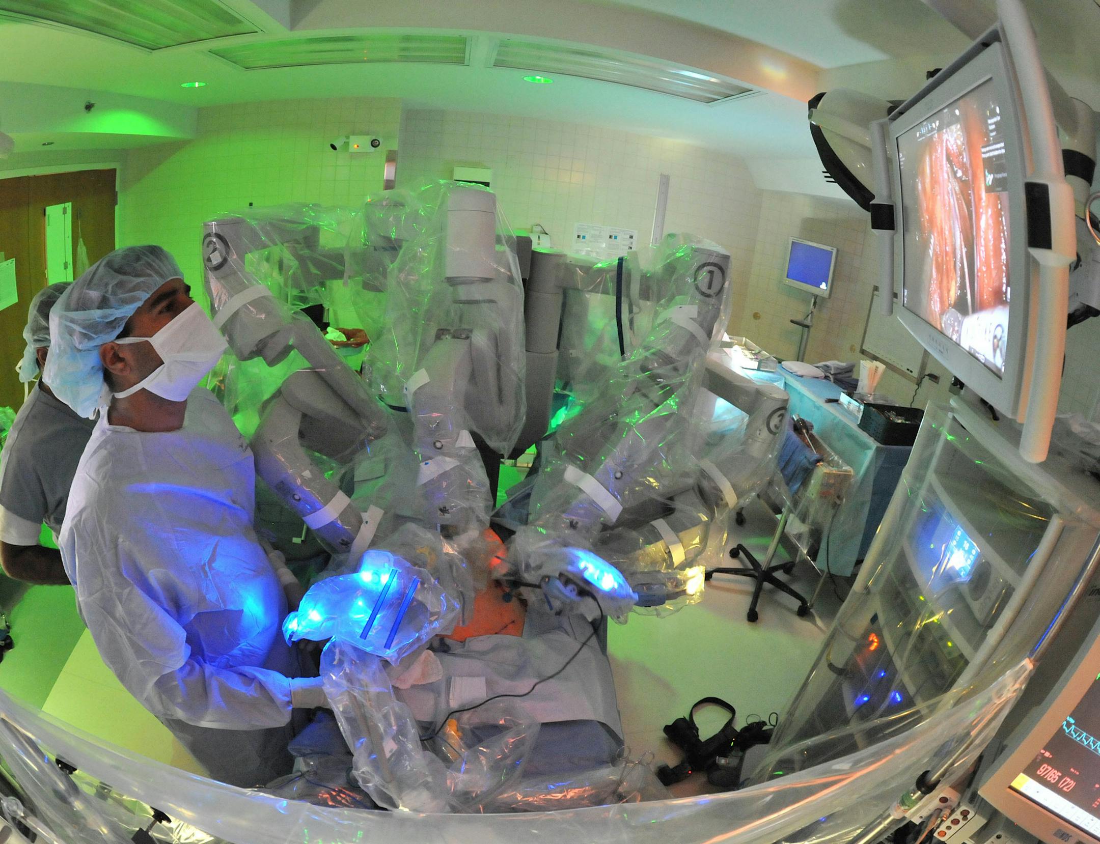 FILE - In this Sept. 13, 2011 photo provided by the University of Chicago Medical Center, a doctor watches an internal video of the patientís body as he assists in prostate cancer surgery at the University of Chicago Medical Center in Chicago. Surgery to remove the prostate saves lives compared to "watchful waiting" for some men whose cancers were found because they were causing symptoms, long-term results from a Scandinavian study suggest. However, U.S. men should not assume that immediate