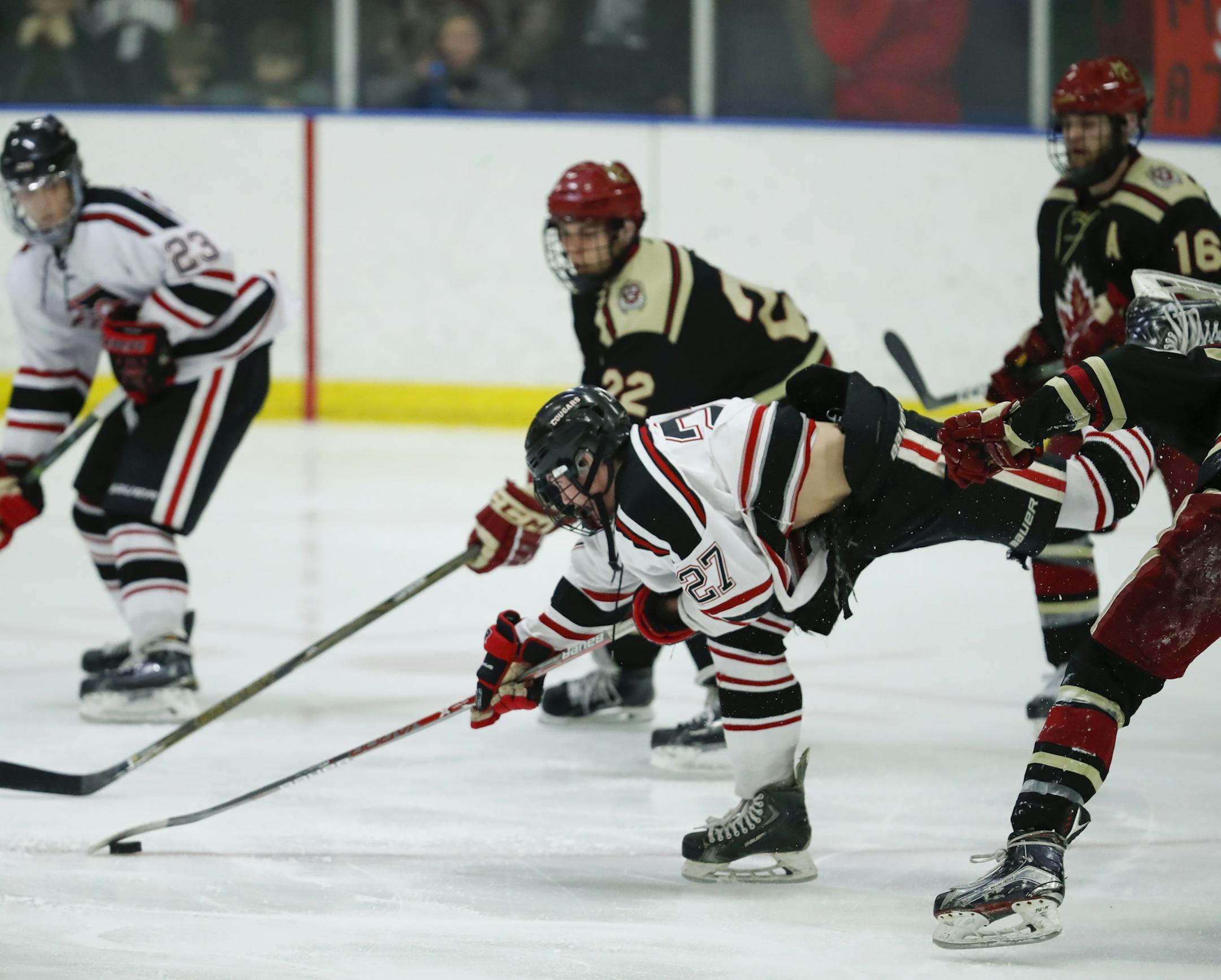 Centennial's Alex Knight was checked off the puck by Maple Grove's Hunter House in the second period. ] JEFF WHEELER ï jeff.wheeler@startribune.com Centennial faced Maple Grove in the Class 2A, Section 5 boy's final hockey final at Aldrich Arena Thursday night, March 2, 2017 in Maplewood.