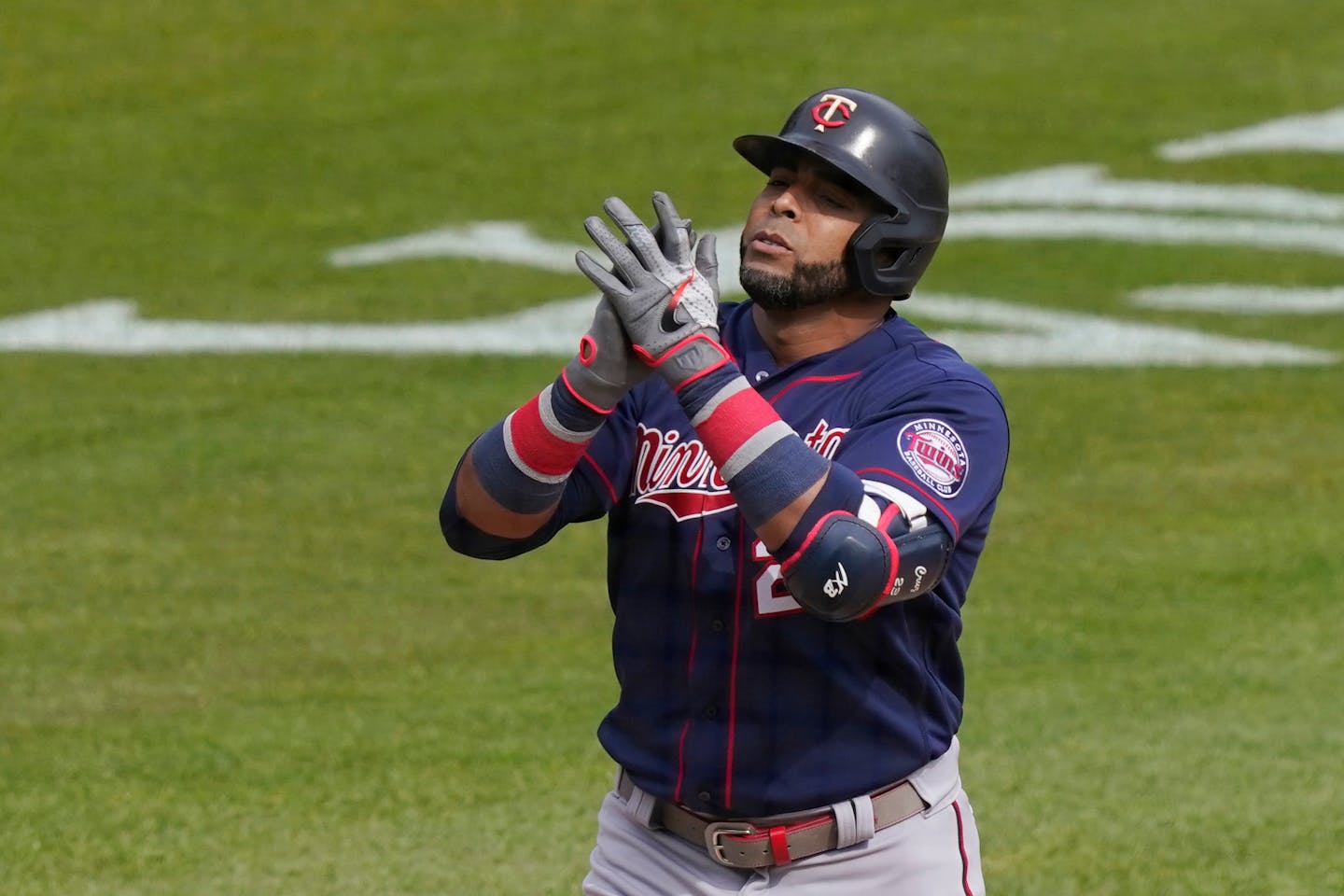 Minnesota Twins designated hitter Nelson Cruz reaches at home plate after a solo home run during the seventh inning of a baseball game against the Detroit Tigers, Tuesday, April 6, 2021, in Detroit. (AP Photo/Carlos Osorio)