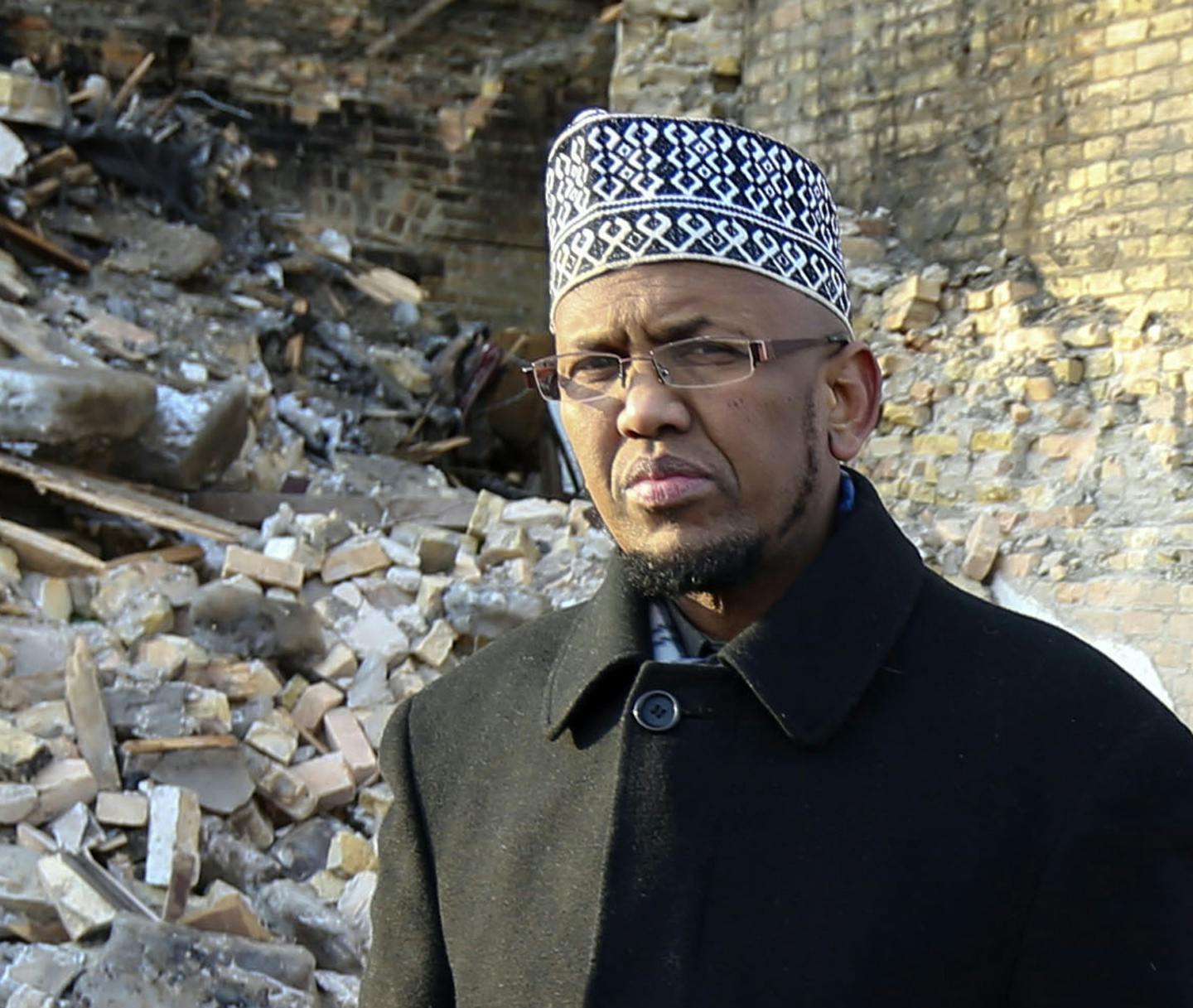 Mohamed outside the destroyed building. His mosque had water damage and may be unusable for months. Prayers will be held Friday at Brian Coyle Center.