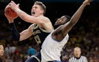 Michigan's Moritz Wagner (13) shoots over Villanova's Eric Paschall (4) during the second half in the championship game of the Final Four NCAA college