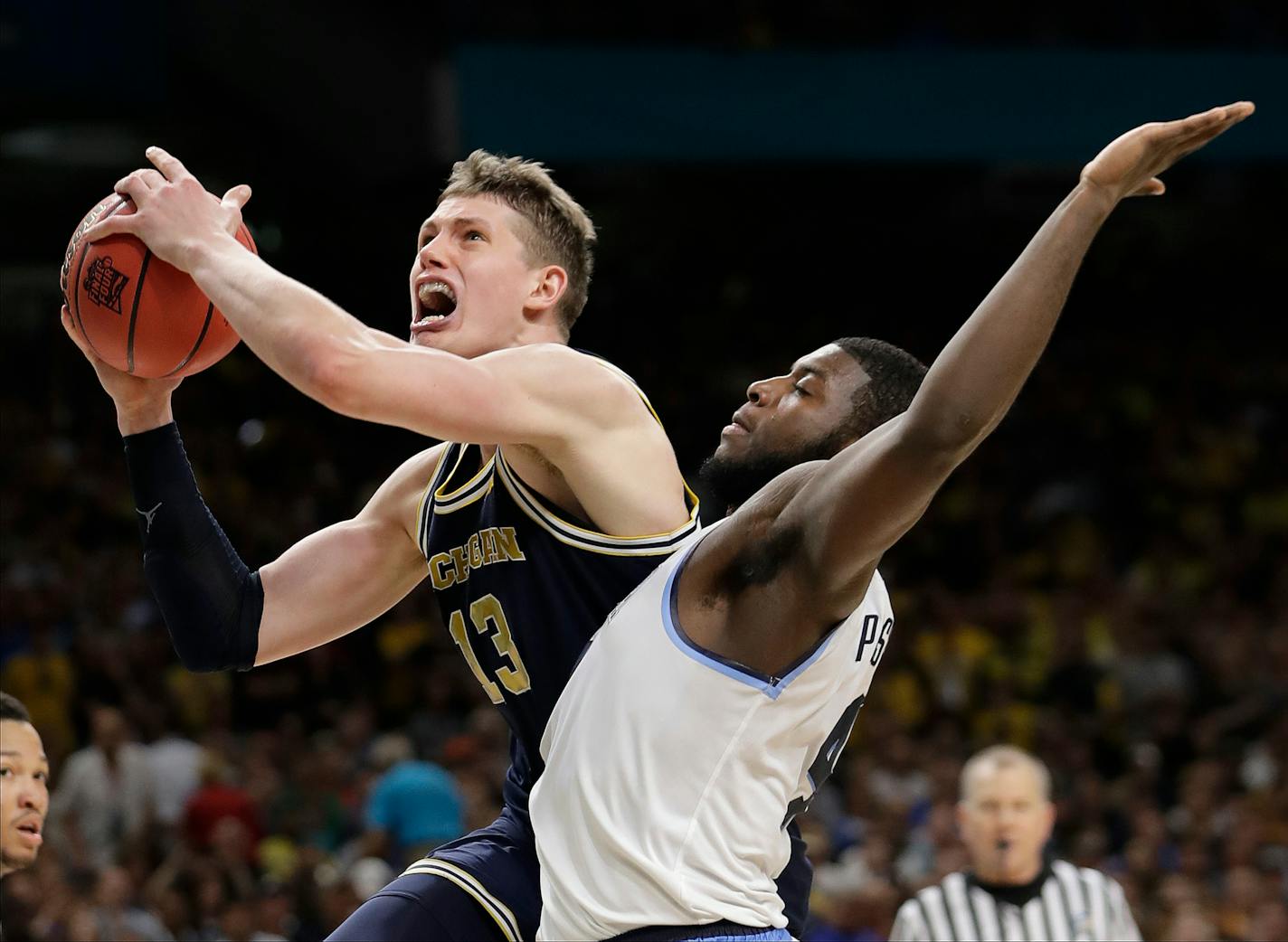 Michigan's Moritz Wagner (13) shoots over Villanova's Eric Paschall (4) during the second half in the championship game of the Final Four NCAA college basketball tournament, Monday, April 2, 2018, in San Antonio. (AP Photo/Eric Gay)