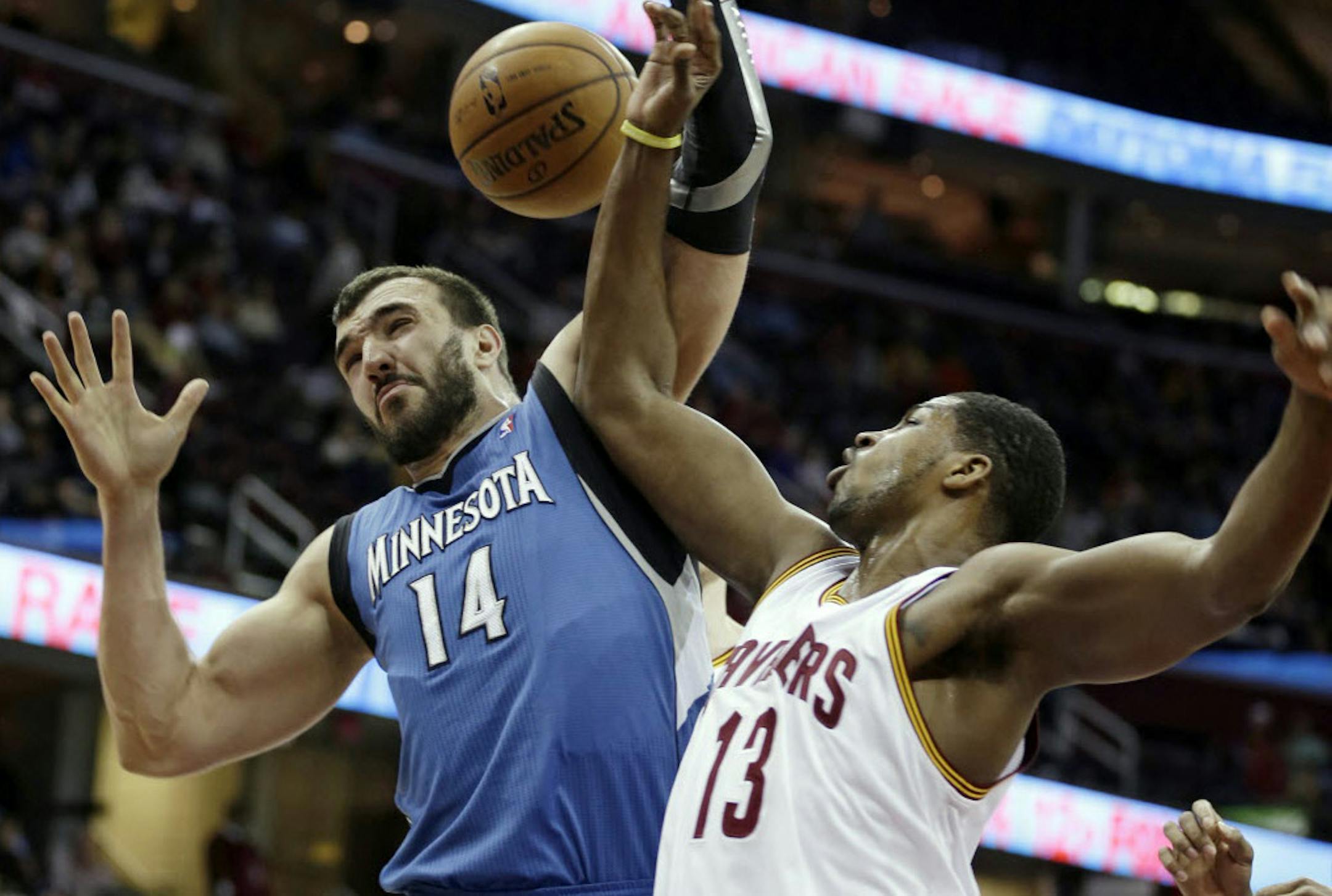 Wolves center Nikola Pekovic (14) and Cleveland's Tristan Thompson battled for a rebound in Minnesota's 100-92 victory Monday.