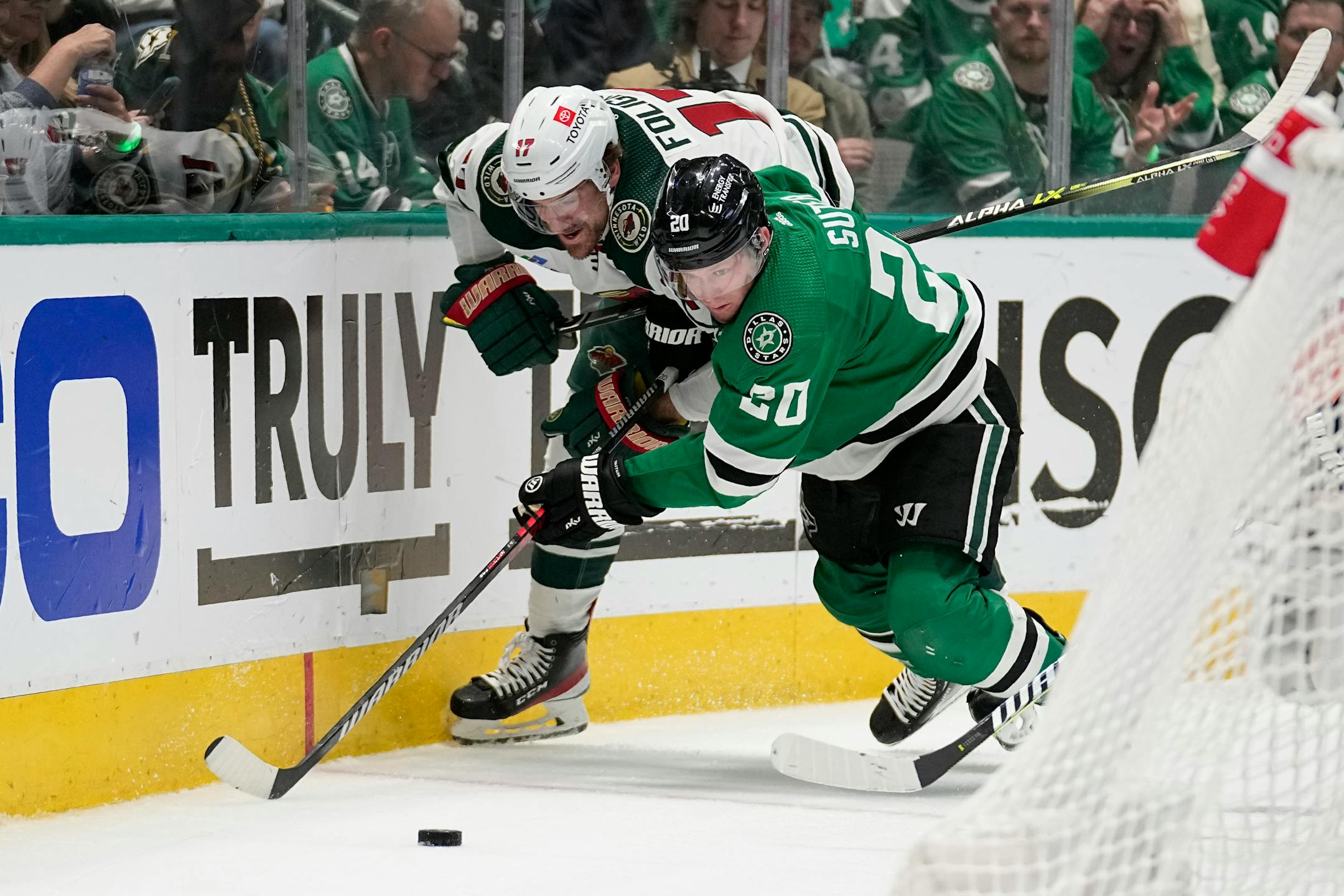 Minnesota Wild left wing Marcus Foligno (17) and Dallas Stars defenseman Ryan Suter (20) compete for control of the puck in the second period.