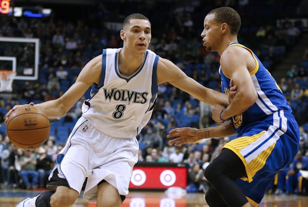 Wolves guard Zach LaVine pushed the ball down the court past Warriors guard Stephen Curry during the first half of Golden State's 102-86 victory at Ta
