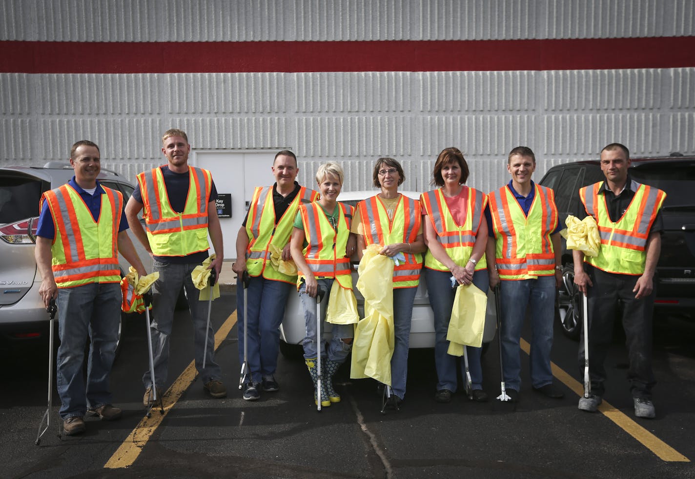 Employees at Miller Auto Plaza in St. Cloud got ready to pick up trash along a highway.