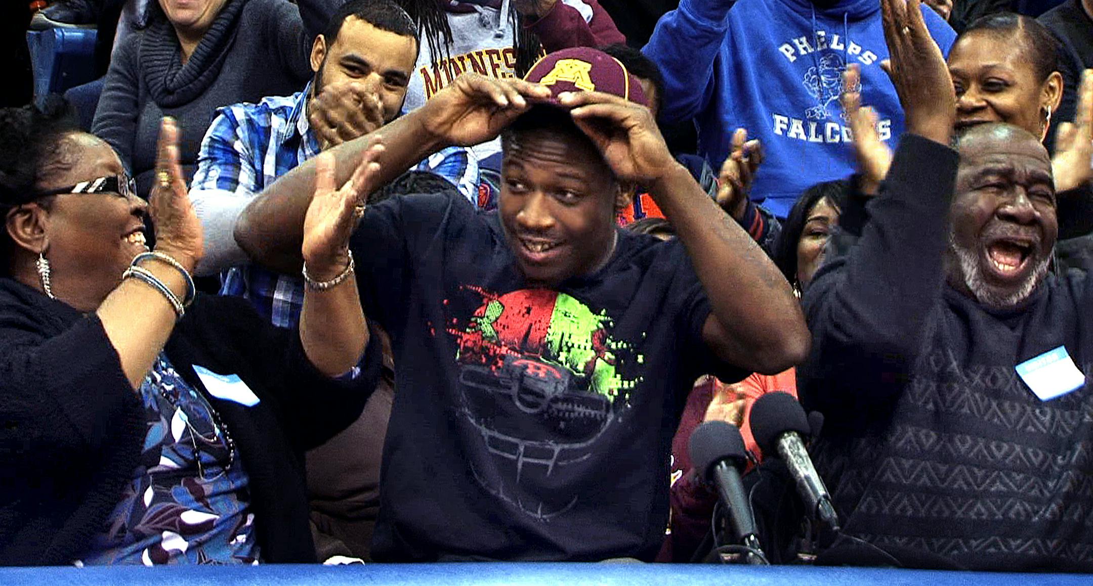 Washburn High School running back Jeff Jones announces his intention to play football at the University of Minnesota by putting a Gophers hat on his head. Alongside Jeff are his grandparents Doris Jones (left), and Willie Jones. Jones made the announcement in front of a full gym at Washburn High School on Wednesday, February 5, 2014. ] SHARI L. GROSS ‚Äö√Ñ¬¢ sgross@startribune.com ORG XMIT: MIN1402051402271677