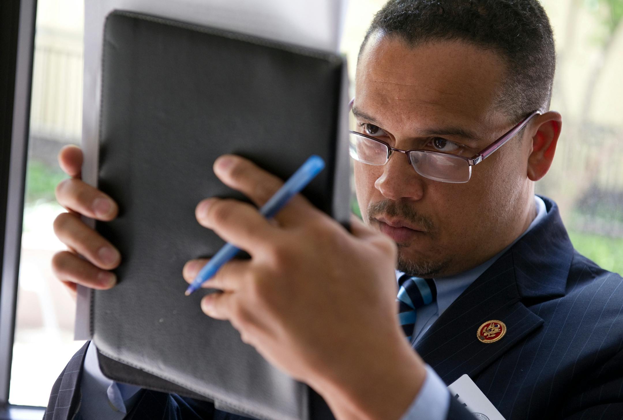 Rep. Keith Ellison, D-MN works on his iPad before taking the stage to be on a panel at the National Youth Economic Policy Forum at the AFL-CIO Washington, D.C. headquarters. 20130508 Photo by Mary F. Calvert