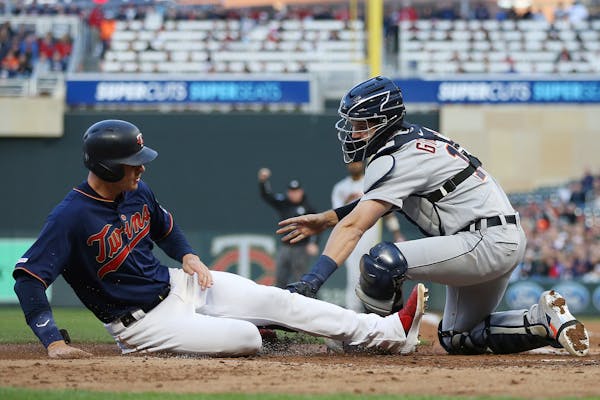 Minnesota Twins' Max Kepler is tagged out at home by Detroit Tigers catcher Grayson Greiner during the third inning of a baseball game Friday, May 10,