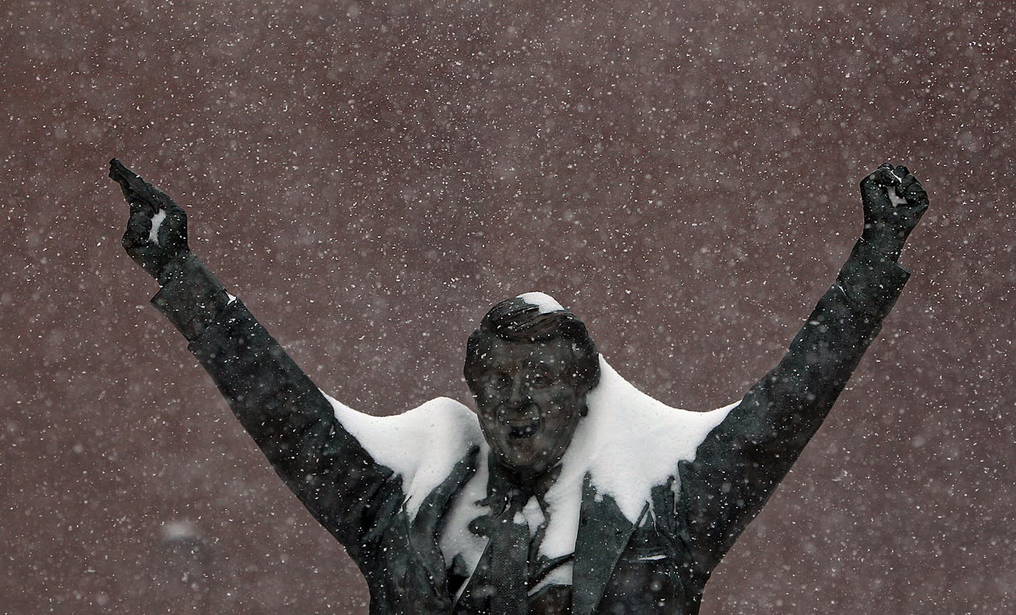 JIM GEHRZ â€¢ jgehrz@startribune.comSt. Paul/December 11, 2010/9:00 AMA major winter snowstorm left streets and sidewalks piled with snow, with high winds and frigid temperatures combining to create near blizzard conditions across southern Minnesota. IN THIS PHOTO:] Snow falls over the bronze statue of former Olympic hockey coach Herb Brooks just outside the Xcel Energy Center.