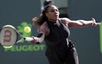 FILE - In this March 21, 2018, file photo, Serena Williams makes a return against Naomi Osaka, of Japan, during the Miami Open tennis tournament in Ke
